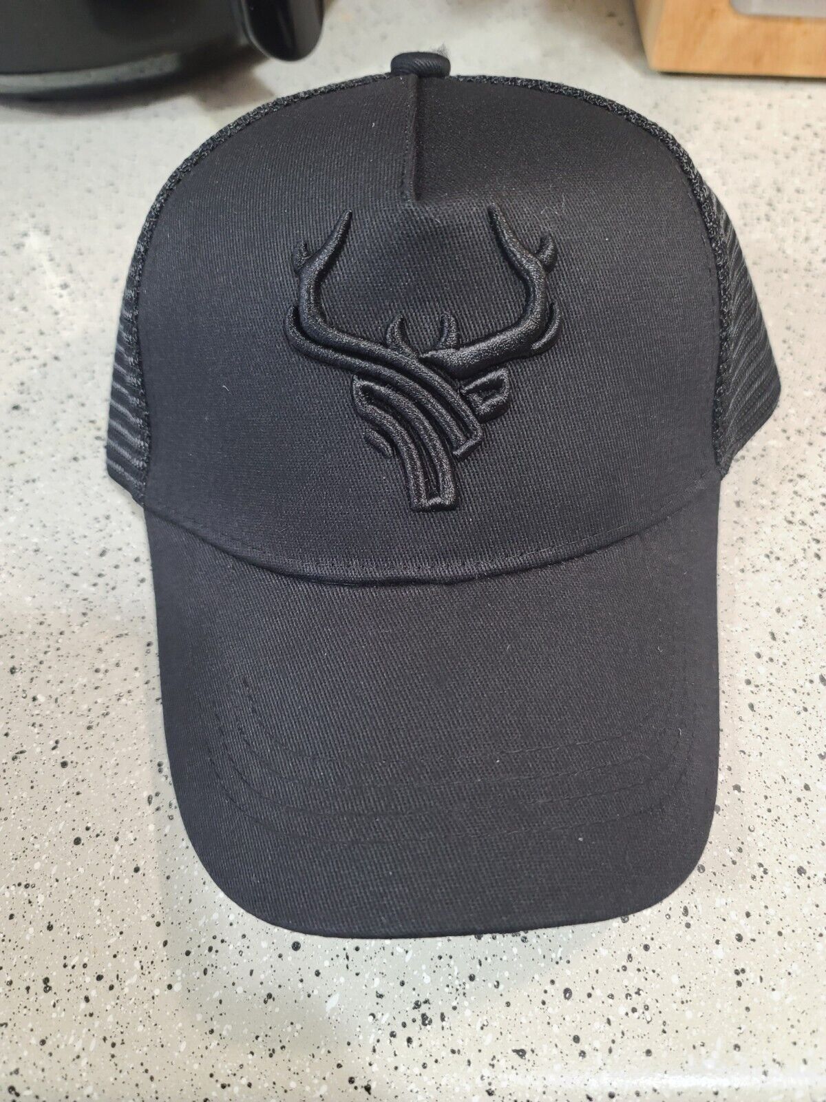 ANTLERS EMBROIDERED TRUCKER MESH HAT.